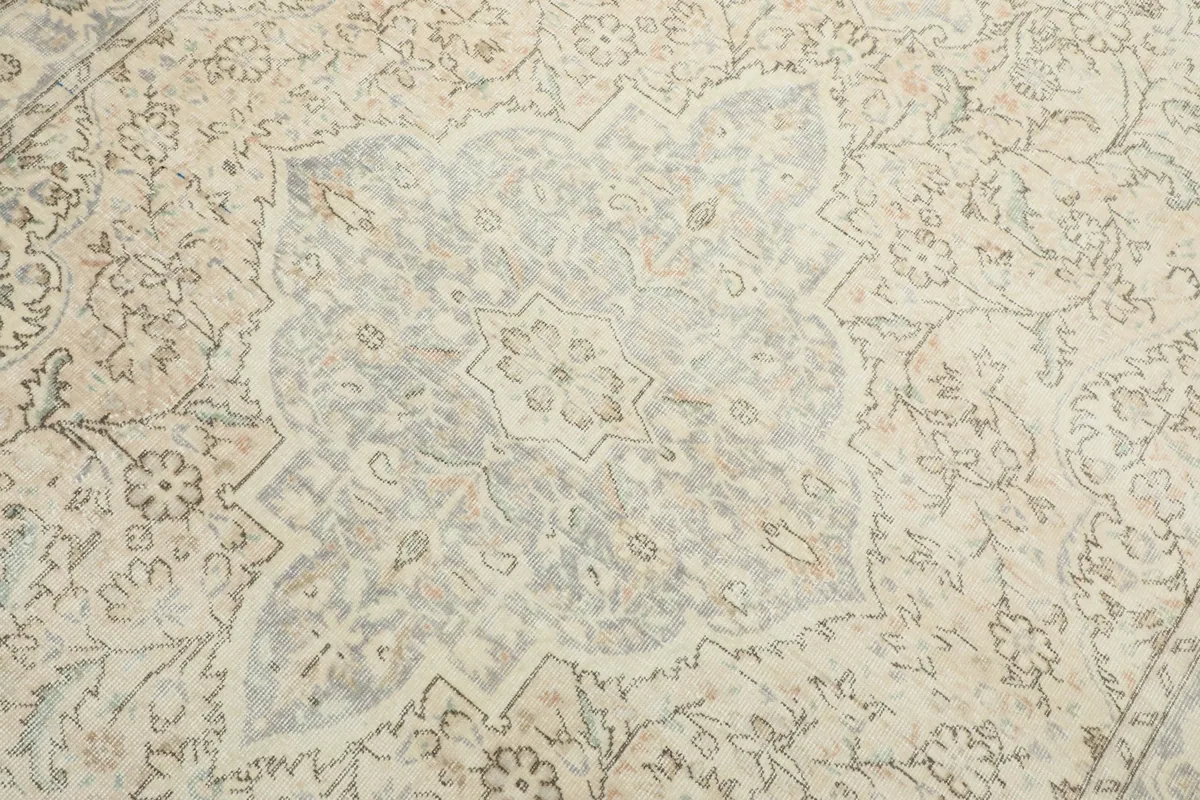 Detailed view of the central blue and cream medallion with intricate floral patterns