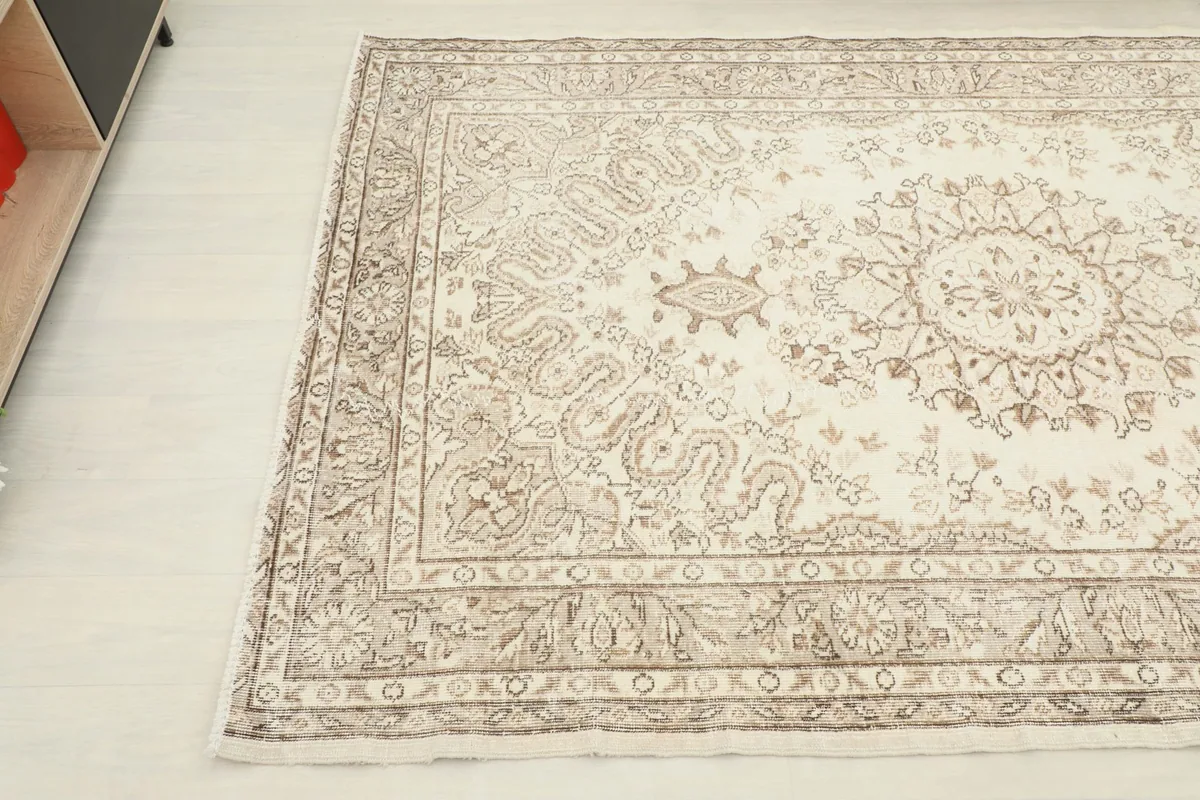 Diagonal view of the vintage rug highlighting the central medallion and border details.