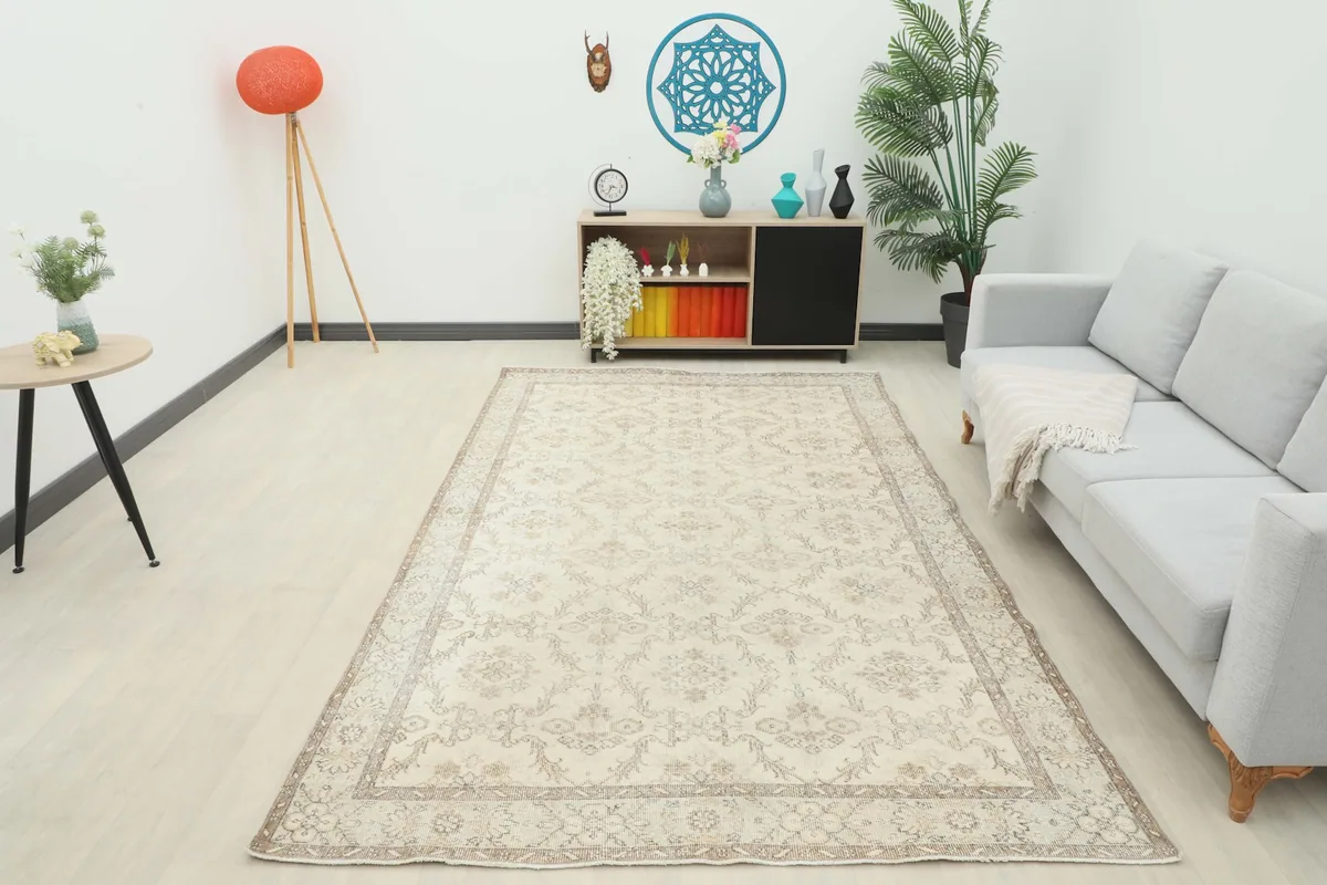 Vintage Anatolian rug displayed in a living room setting with a gray sofa