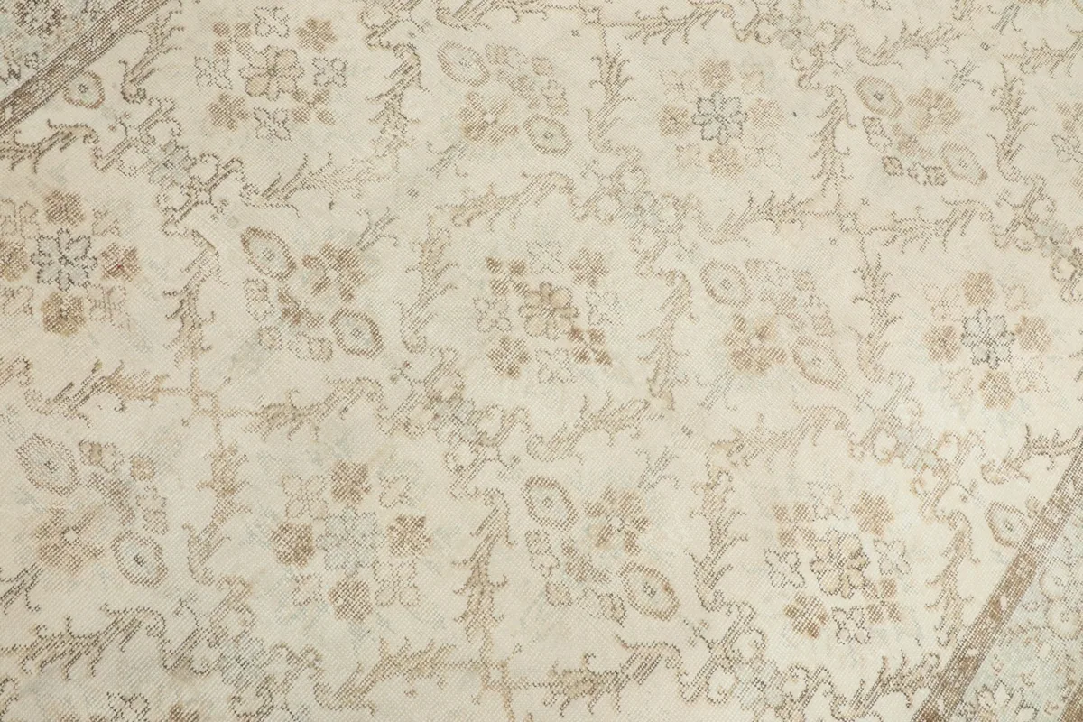 Detailed view of the central floral and geometric motifs on the ivory field