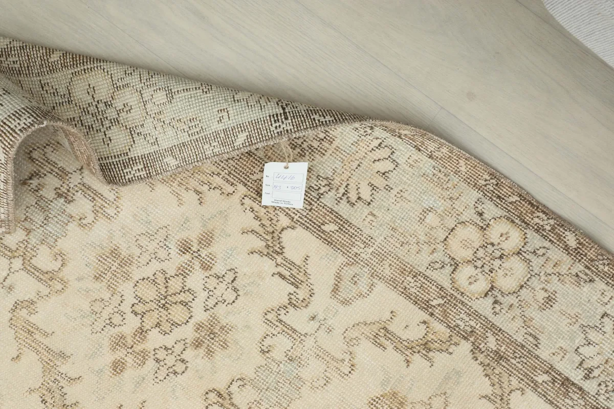 Close-up of the rug's reverse side and edge, with a small tag visible
