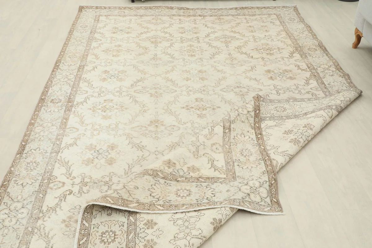 Large section of the rug folded, showing the flexibility and construction of the vintage piece