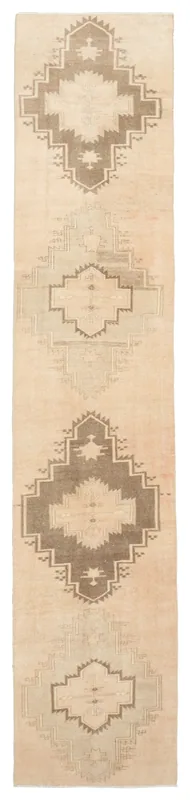 Full overhead view of the beige and brown geometric vintage Anatolian runner on a white background.