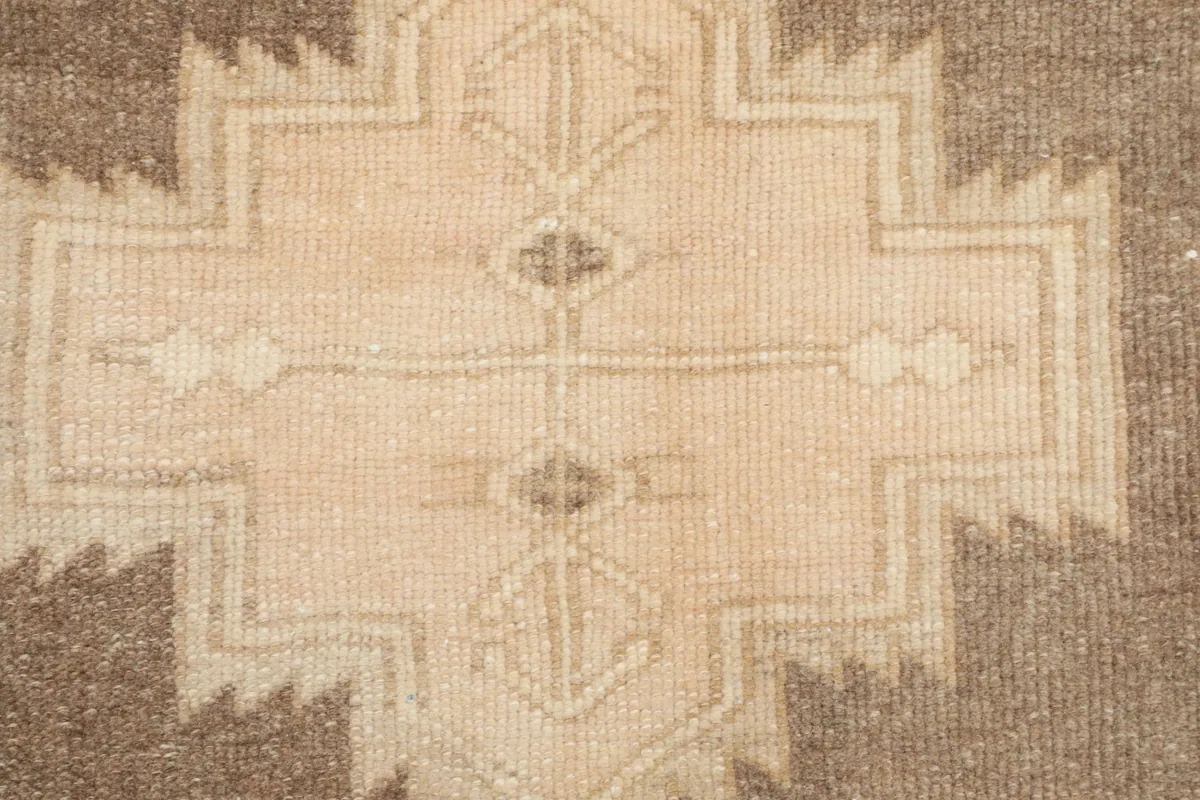 Very close detail of the central geometric pattern, highlighting the hand-knotted wool.