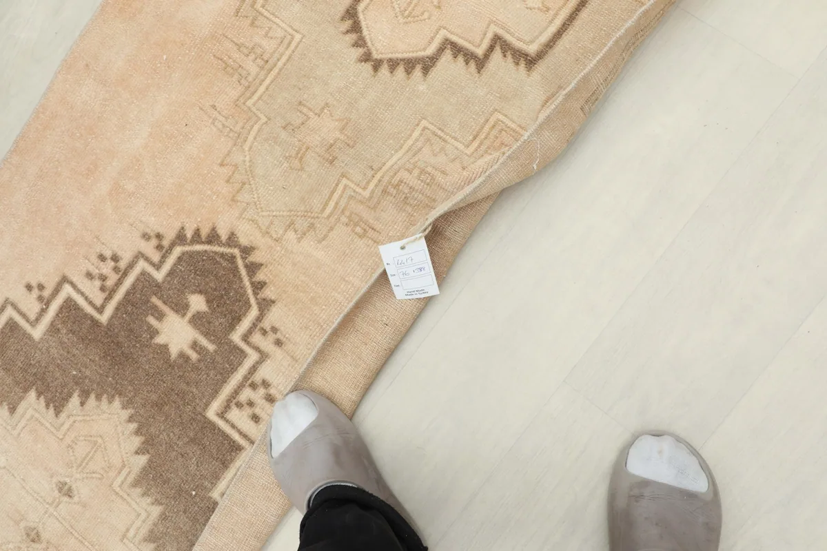 Top-down view of a person's feet on the runner, showing its scale and texture.