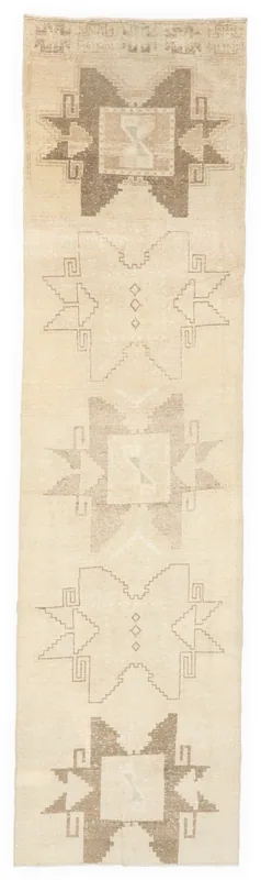 Full top view of the 2'8" x 11'4" vintage ivory and brown geometric Anatolian runner rug