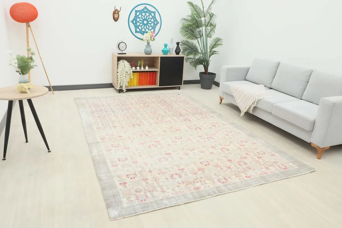Vintage Anatolian rug displayed in a bright living room setting with a light gray sofa.