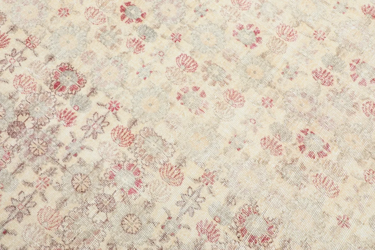 Close-up detail of the rug's surface, revealing the intricate rose and gray floral patterns.