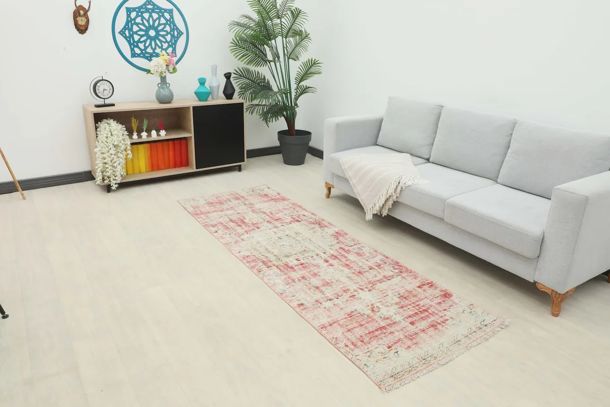 Runner rug displayed in a bright room setting with a light gray sofa and modern decor