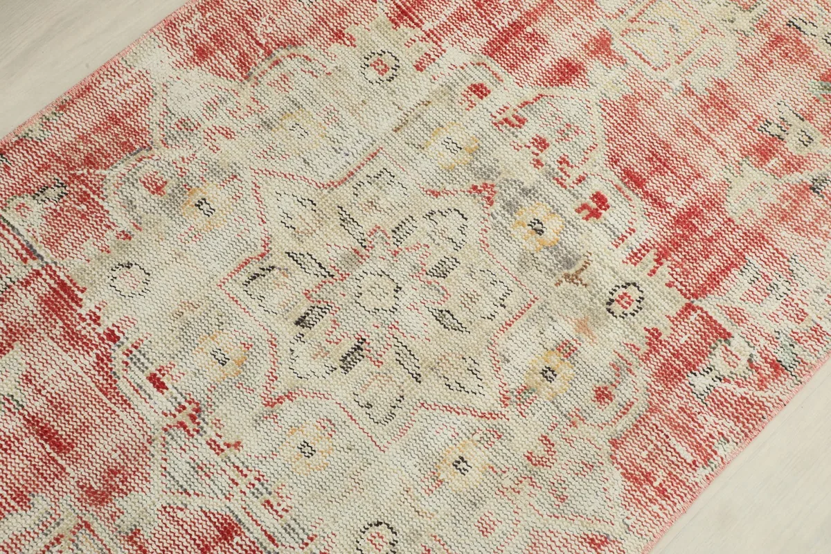 Close-up of the central medallion motif, showing the intricate hand-knotted details and colors