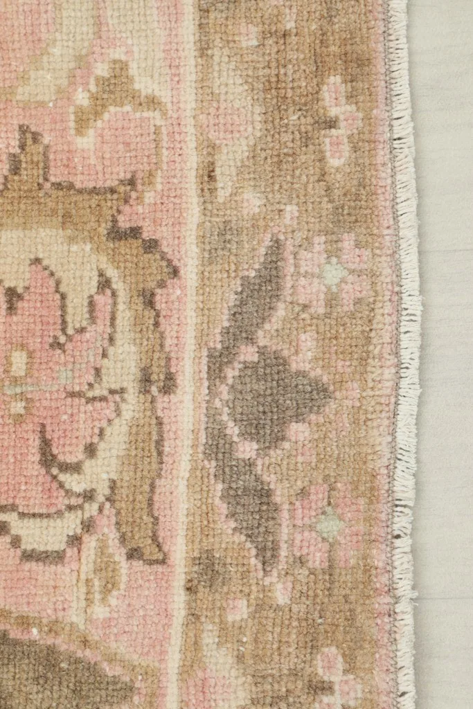 Side view of the rug's low pile and fringe, highlighting the hand-knotted wool on cotton foundation