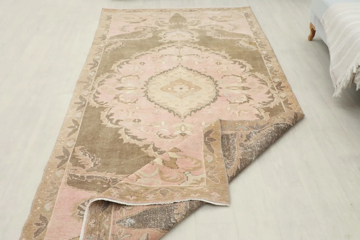 Rug partially folded, demonstrating its flexibility and the overall pattern from a different perspective