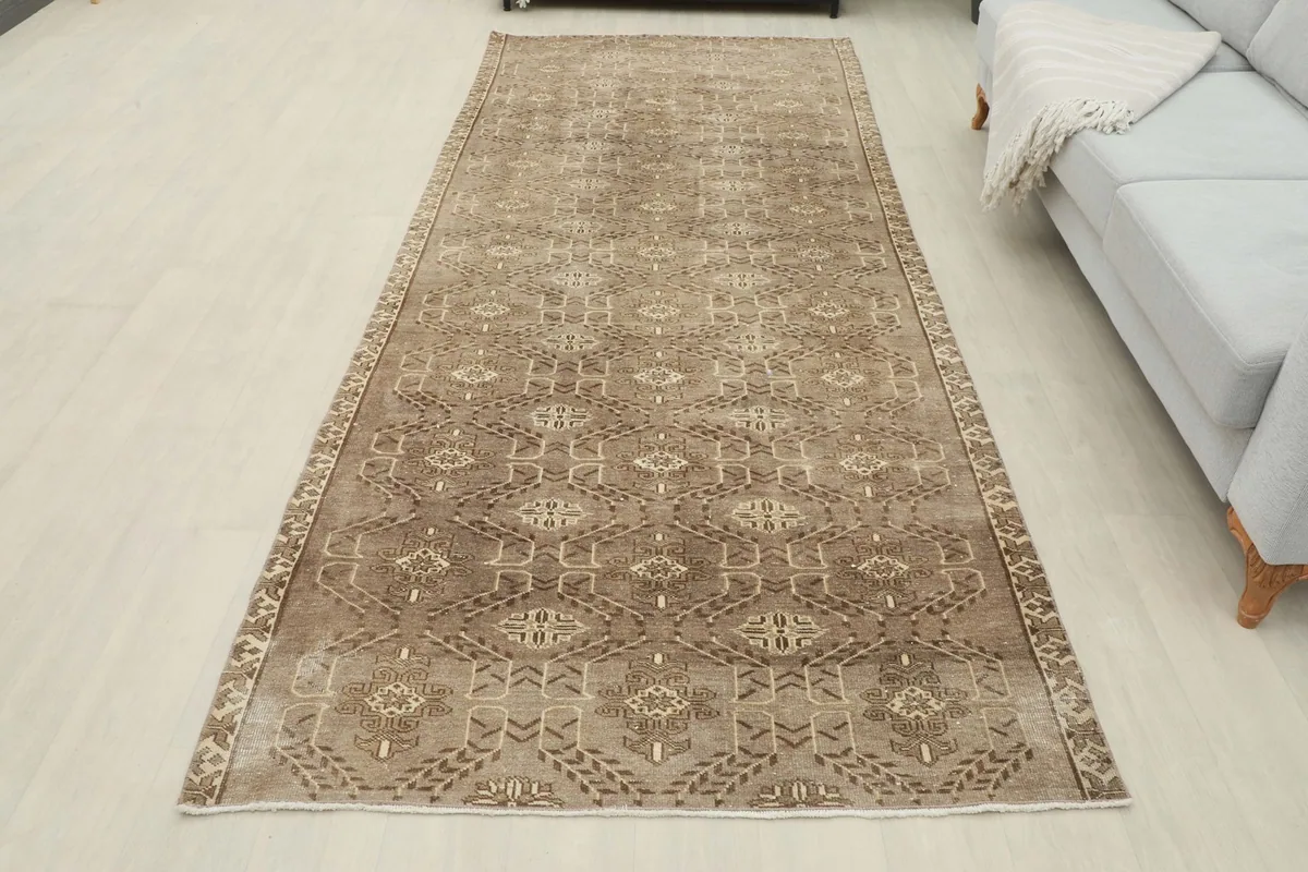 Full length view of the brown runner rug laid out in a room, showcasing its overall appearance.