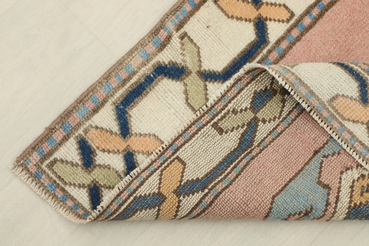 Corner of the runner folded to show the wool pile and cotton foundation.
