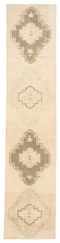 Full top view of the cream and brown geometric runner rug on a white background