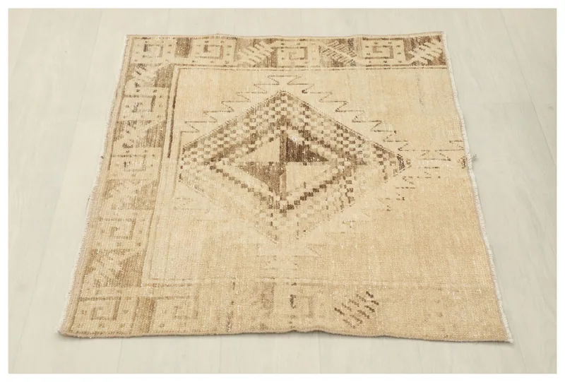 Full top view of the beige and brown hand-knotted vintage Anatolian rug