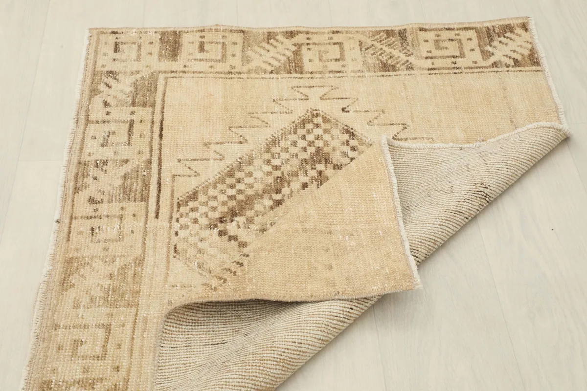 Rug folded to show both the pile side and the cotton foundation