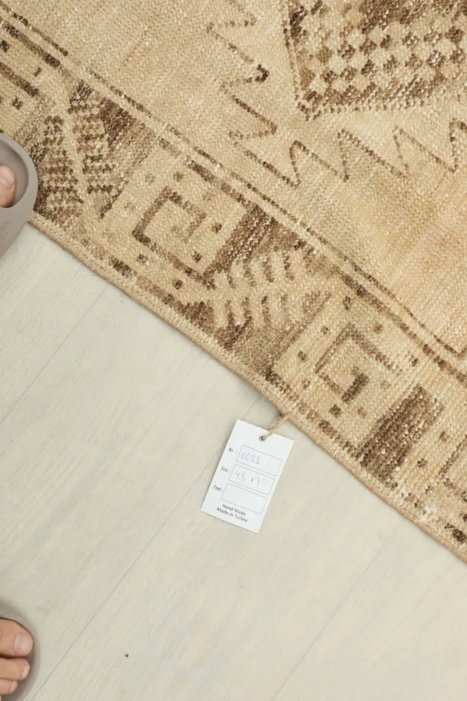 Top-down view of a small label next to the rug, indicating product information
