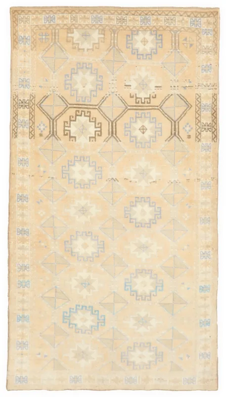 Full overhead view of the beige geometric medallion vintage Anatolian rug