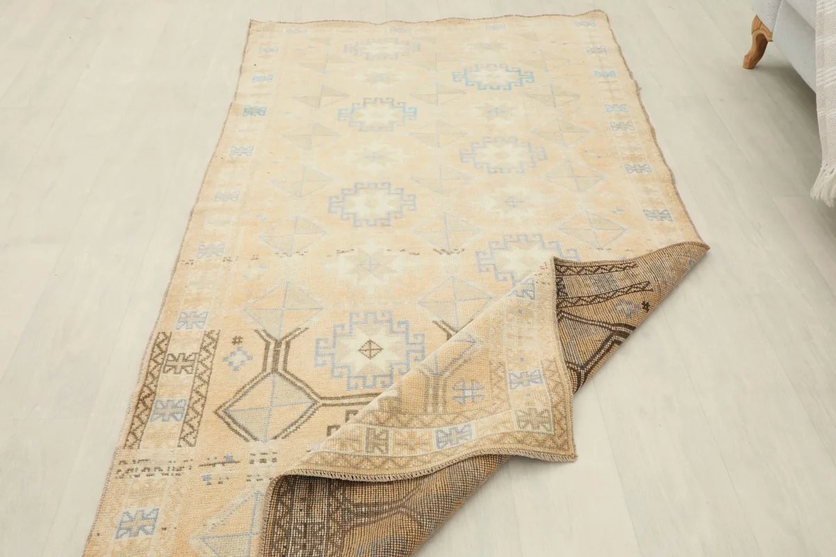 View showing the rug's flexibility and the back of the hand-knotted cotton foundation
