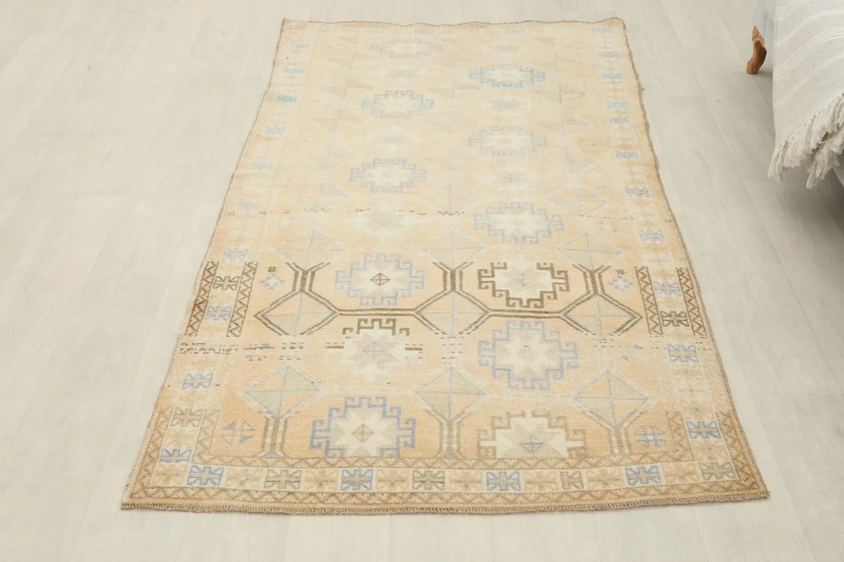 Overhead view of the beige geometric rug from a slightly elevated perspective