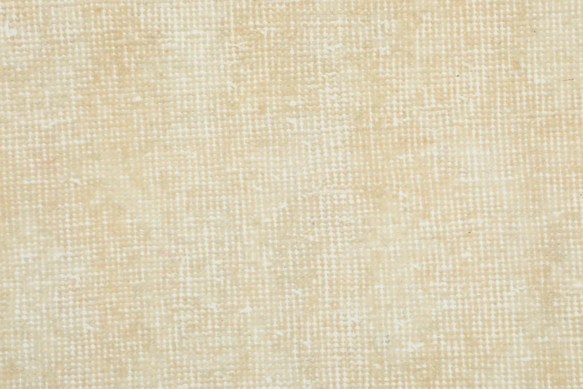 Close-up of the low wool pile texture on the cream field of the rug
