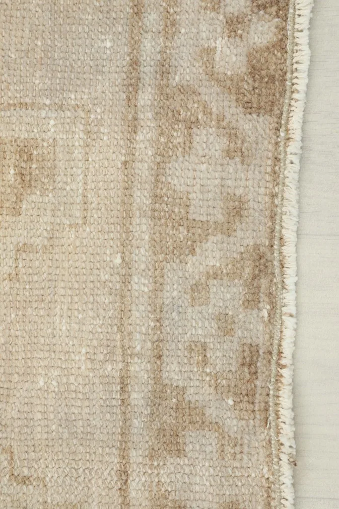 Close-up of the low wool pile and the finished edge of the vintage Anatolian runner