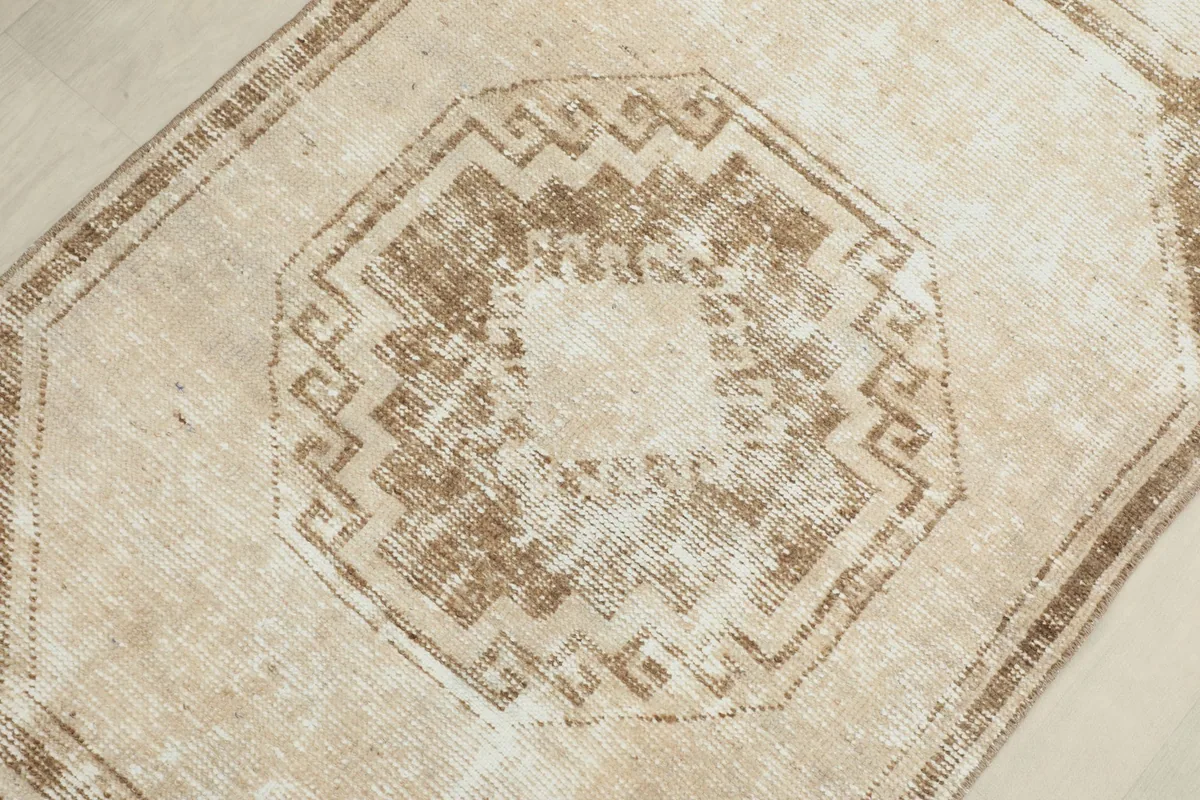 Macro shot of a central geometric motif within a medallion, highlighting texture and color variation