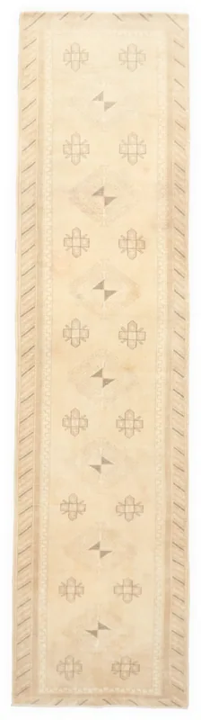 Full top view of the 2'7" x 11'0" ivory vintage Anatolian runner with geometric tribal patterns.