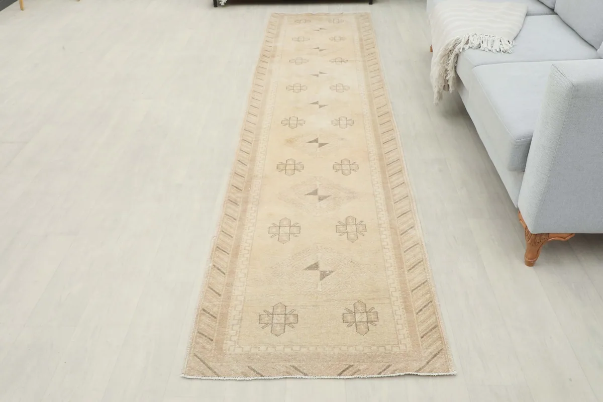 Full room view of the ivory runner rug laid out, providing context for its size and design.