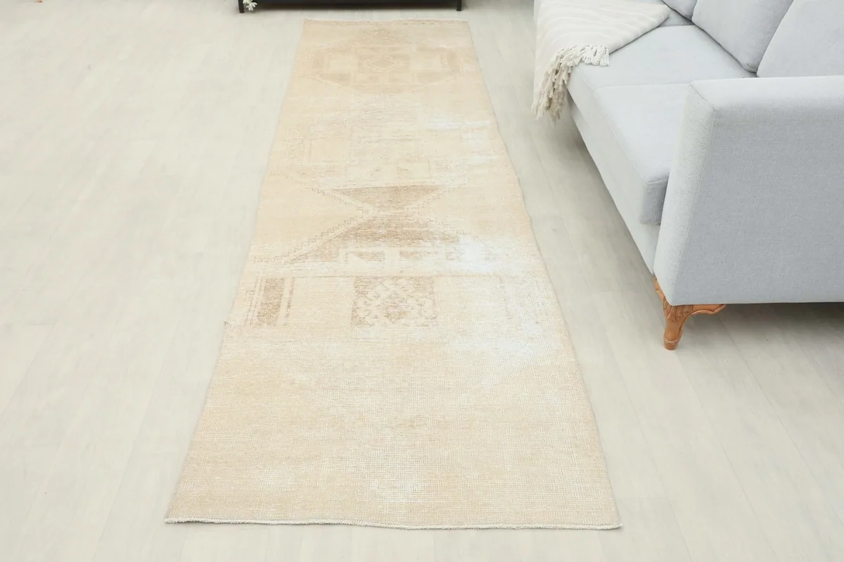 Full room view of the beige runner extending from a console table towards a sofa.
