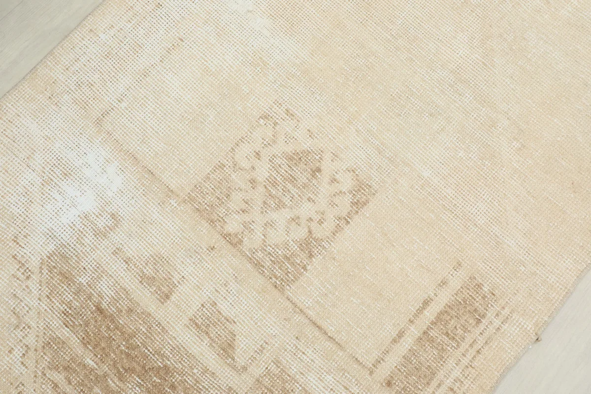 Close-up of a central geometric pattern on the runner, showing the texture and distressed look.