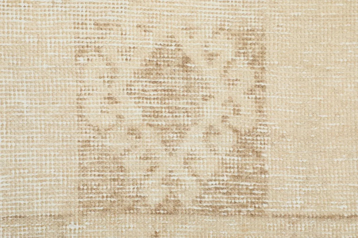 Tight detail of the hand-knotted wool pile and cotton foundation, revealing the weave.