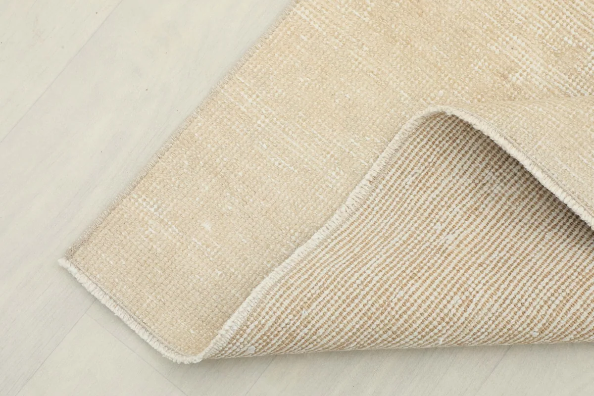 View of the reverse side of the runner, showing the tightly woven cotton foundation.