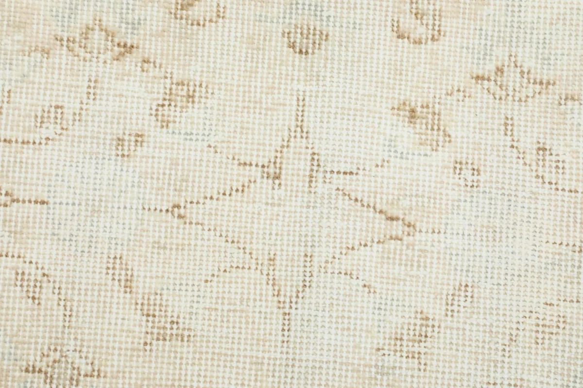 Macro detail of the hand-knotted texture and a distinct geometric motif within the rug.