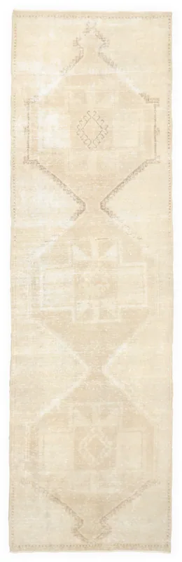 Full top view of the beige geometric vintage runner rug on a white background