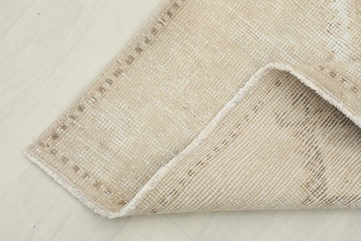 Corner of the runner folded to show the wool pile on cotton foundation and the reverse side