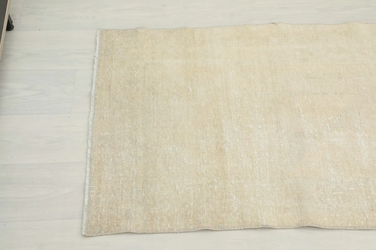 Close-up of the opposite end of the beige runner, highlighting the low pile