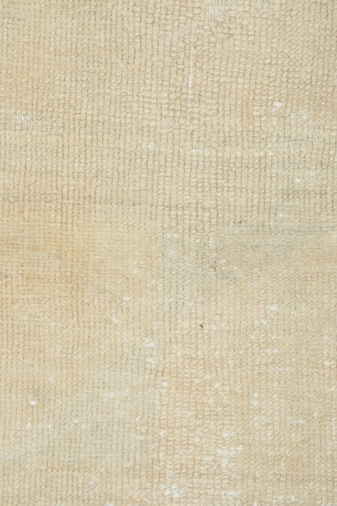 Overhead close-up of the low wool pile, revealing the hand-knotted structure
