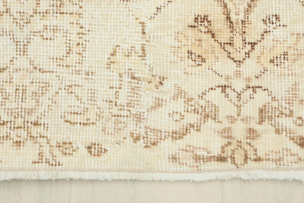 Detailed view of the rug's fringe and the edge of the low pile