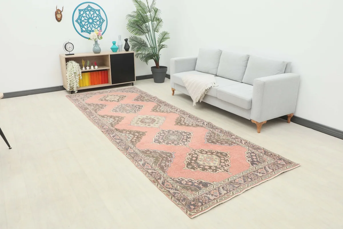 Runner rug displayed in a living room setting with a light-colored couch and modern decor