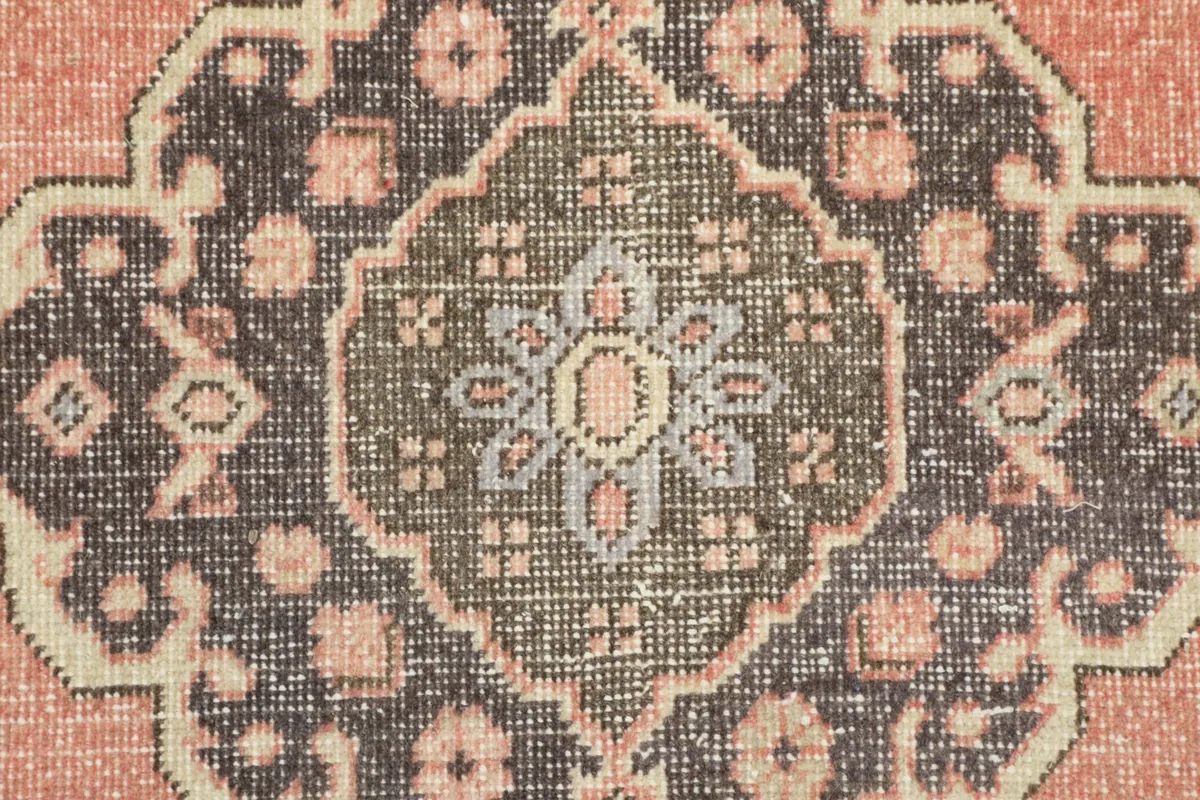 Detailed view of the intricate geometric floral design within a charcoal medallion