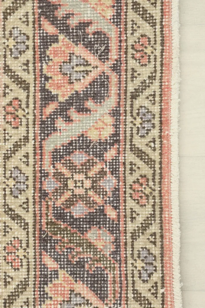 Close-up of the runner's border, showing patterned details and colors
