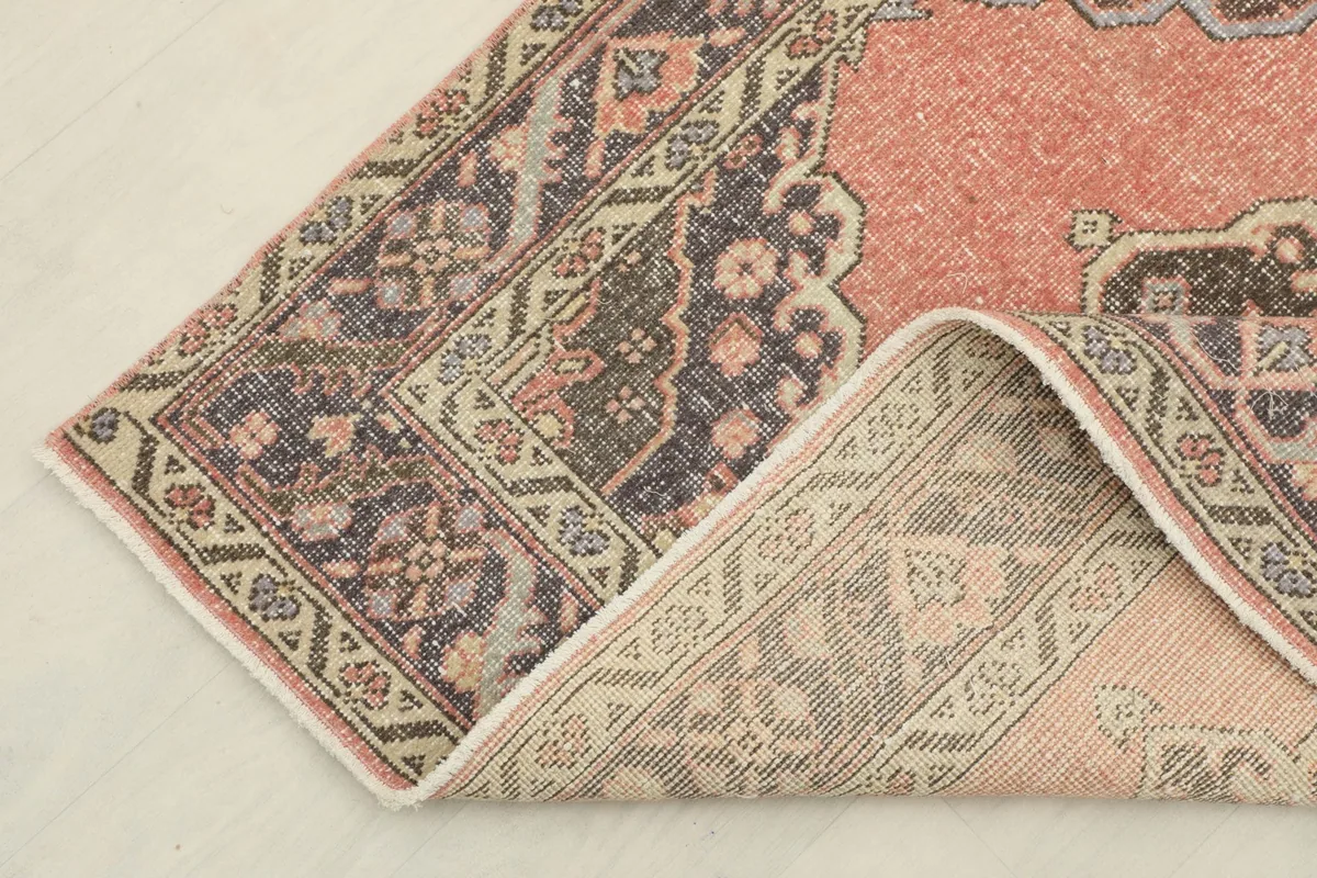 Corner of the runner folded back to reveal the back of the rug and its construction