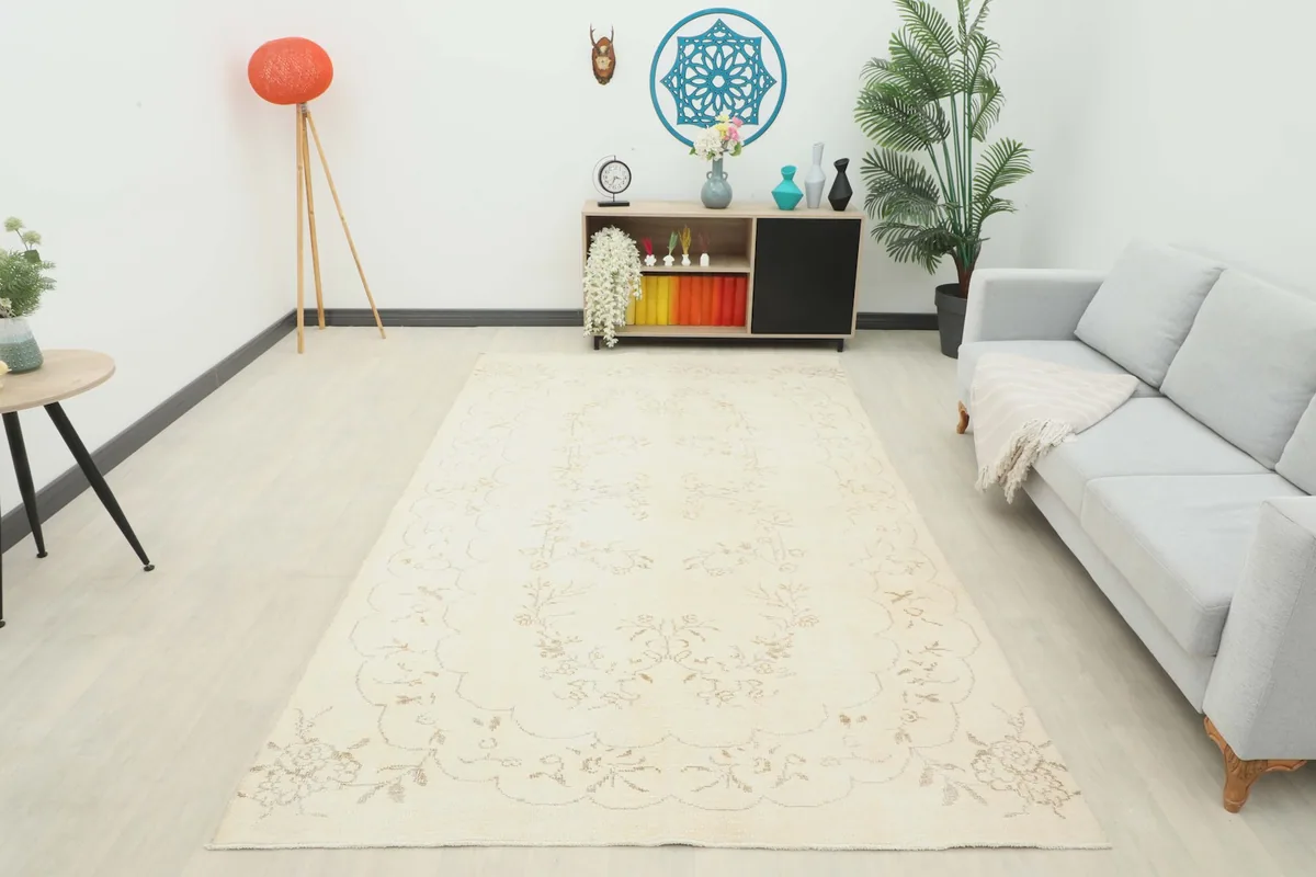 Wide shot of the ivory floral vintage rug in a living room, showing its full presence in the space