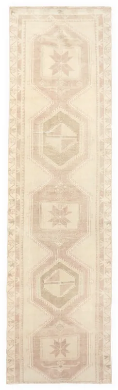 Full top view of the 3'4" x 12'5" beige and rose geometric vintage Anatolian runner rug on a white background.