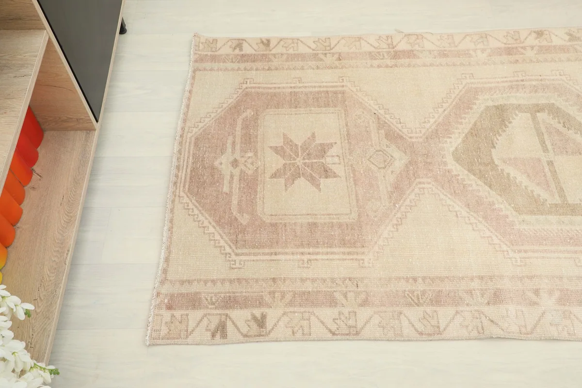 Overhead angle view capturing the central geometric motifs and the subtle color variations of the runner.