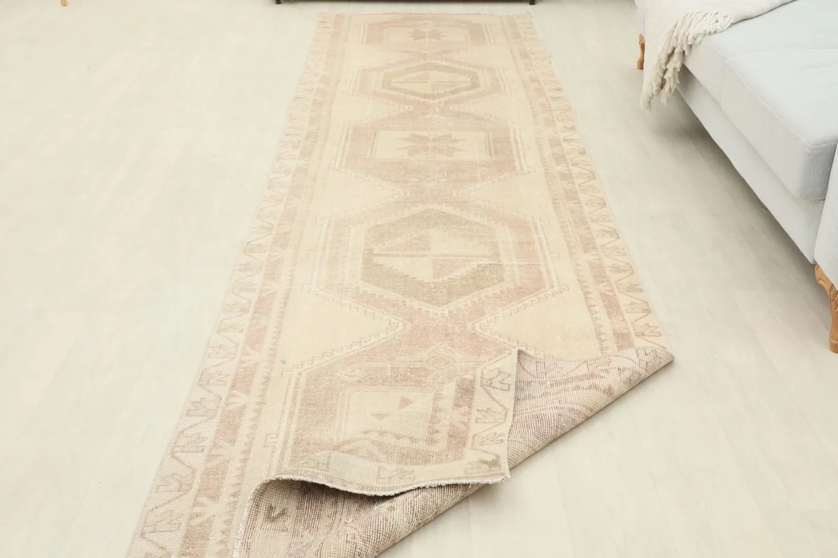 Runner rug partially unrolled, showing its flexibility and the overall length in a room setting.