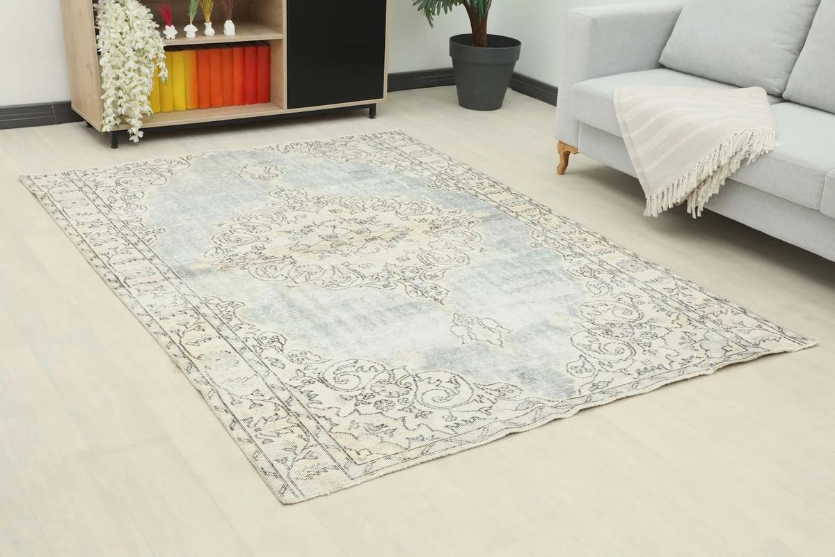 Angle view of the faded gray rug in a living space, showing its placement relative to furniture