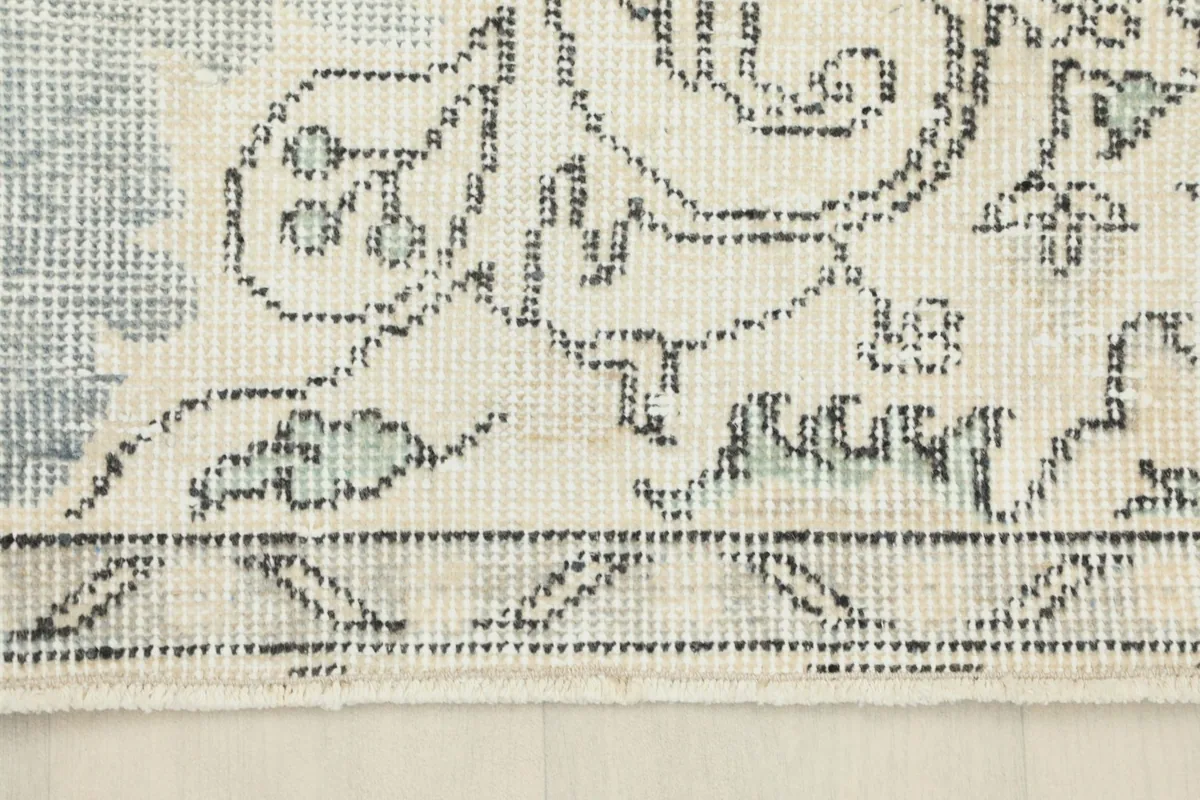 Detail of the rug's border design, displaying geometric and floral motifs